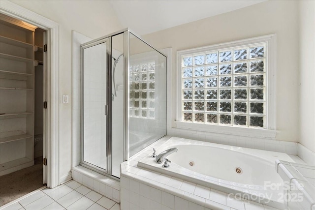 full bath featuring a stall shower, tile patterned flooring, and a jetted tub