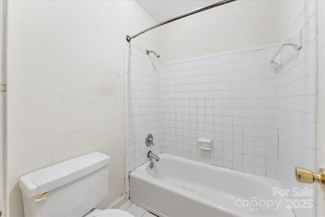 bathroom with shower / bathing tub combination and toilet