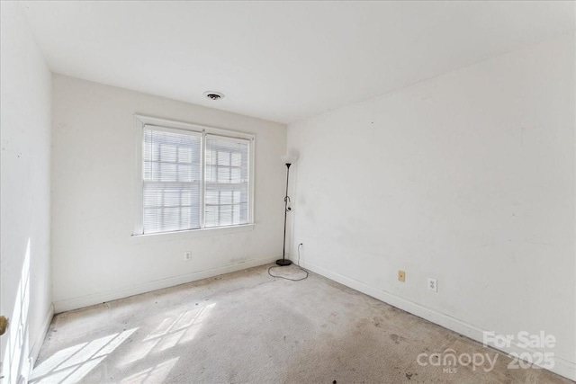 carpeted empty room with visible vents and baseboards