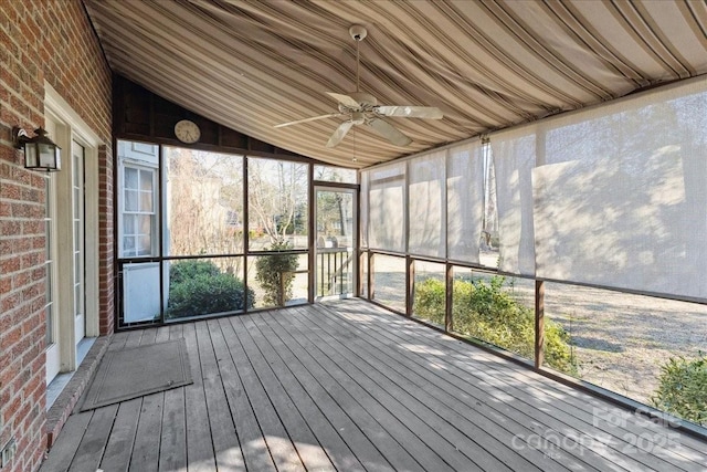 unfurnished sunroom featuring ceiling fan and vaulted ceiling