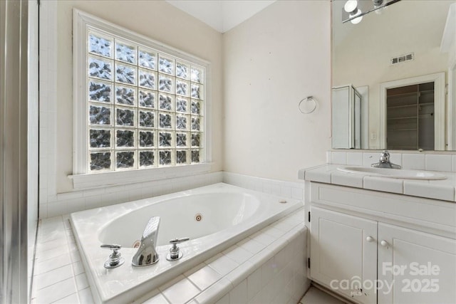 full bathroom with a whirlpool tub, vanity, and visible vents