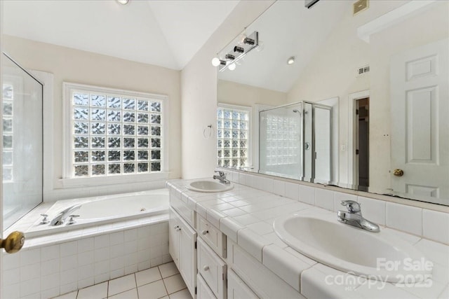 full bath with a garden tub, a sink, visible vents, vaulted ceiling, and a stall shower