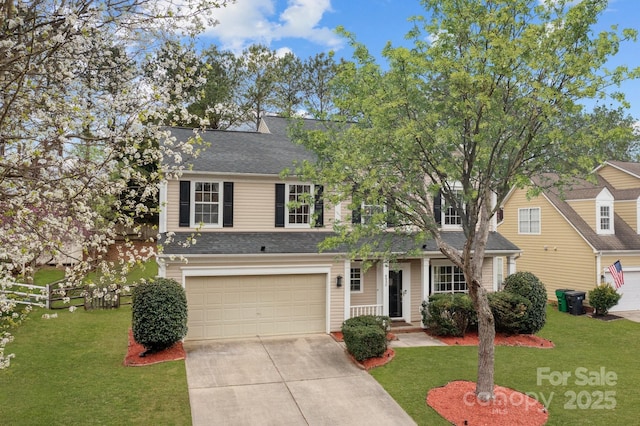 view of front of house featuring a garage, concrete driveway, a front lawn, and a shingled roof