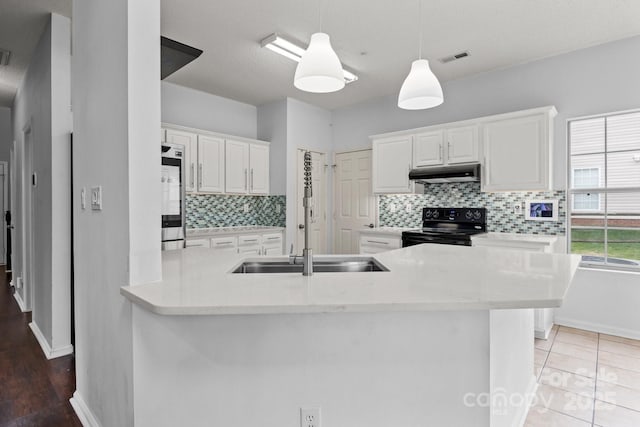 kitchen featuring under cabinet range hood, white cabinets, smart refrigerator, and black range with electric cooktop