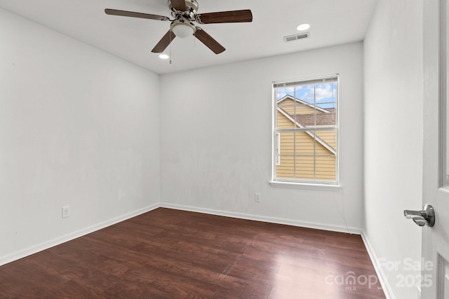 empty room featuring recessed lighting, wood finished floors, visible vents, and baseboards