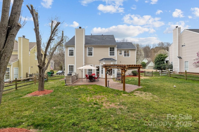 rear view of house featuring a yard, a fenced backyard, a pergola, and a patio