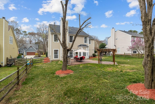 back of house with a fenced backyard, a yard, a pergola, and a patio