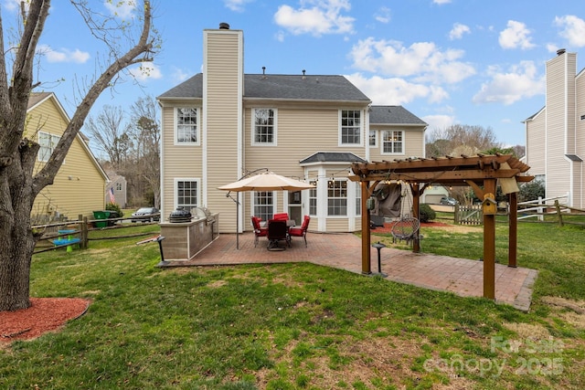 back of property with a fenced backyard, a pergola, a chimney, a patio area, and a lawn