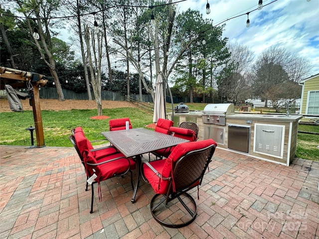 view of patio / terrace with area for grilling, a grill, outdoor dining space, and a fenced backyard