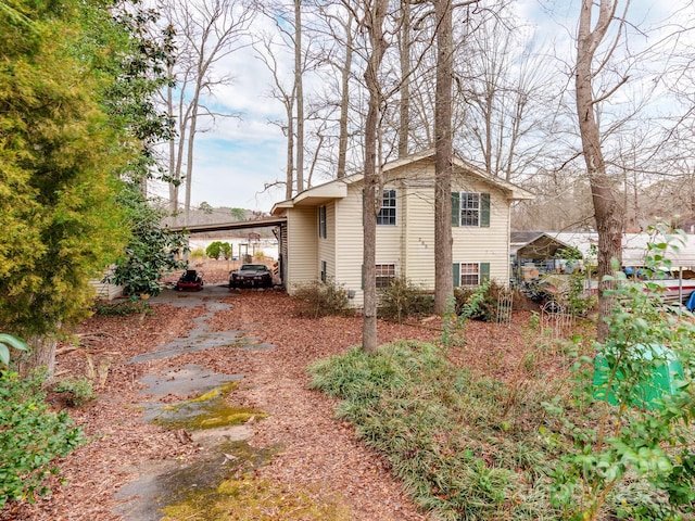 view of side of home with a carport