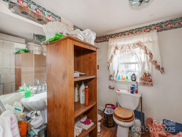 bathroom featuring toilet and wood finished floors