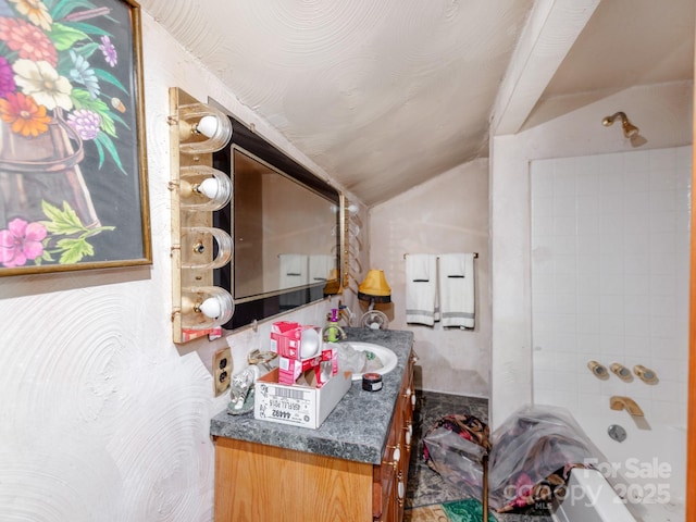 full bathroom featuring vanity, shower / tub combination, and lofted ceiling