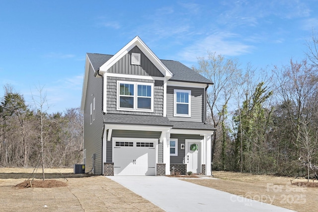 view of front of house with driveway, a garage, board and batten siding, and roof with shingles