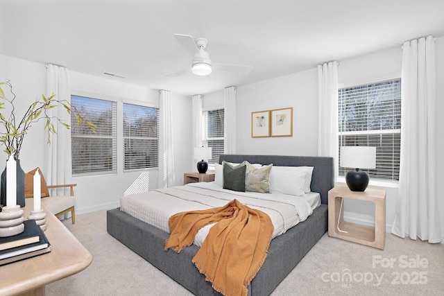 bedroom with carpet, visible vents, and ceiling fan