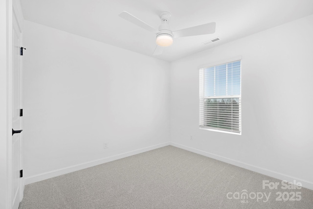 empty room with visible vents, ceiling fan, light carpet, and baseboards