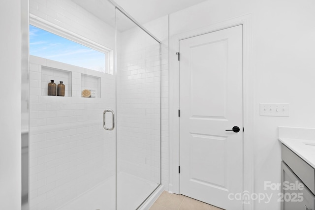 bathroom featuring a stall shower, vanity, and tile patterned floors