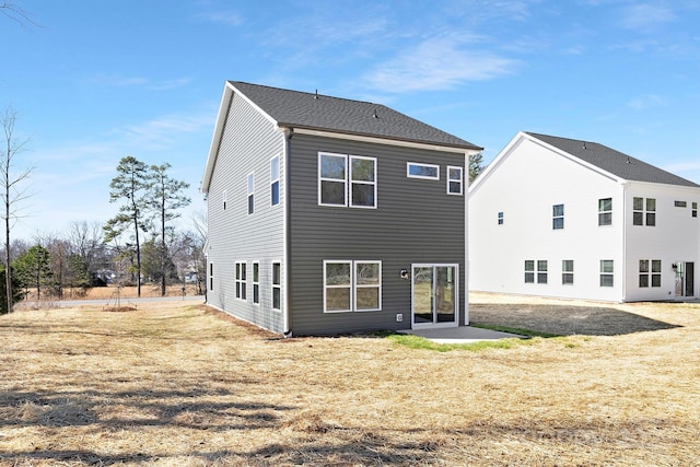 back of property featuring a patio area and a yard