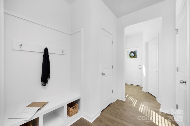 mudroom with wood finished floors and baseboards