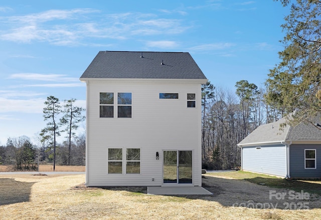 back of property with roof with shingles