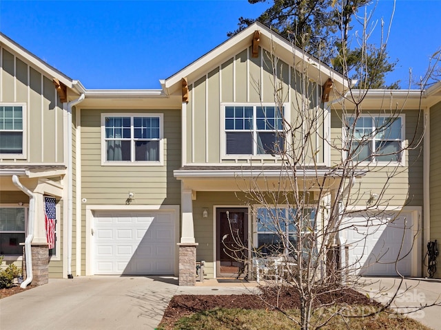 view of front of property with a garage, driveway, and board and batten siding