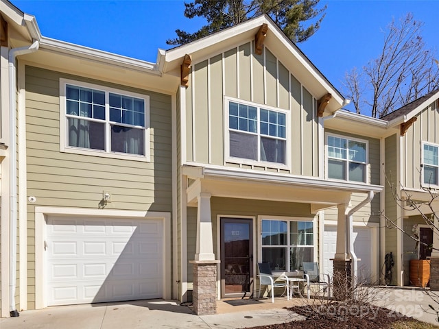 view of front of home featuring a garage, covered porch, and board and batten siding