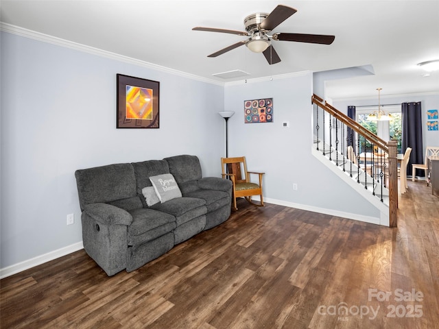 living room with stairs, crown molding, baseboards, and wood finished floors