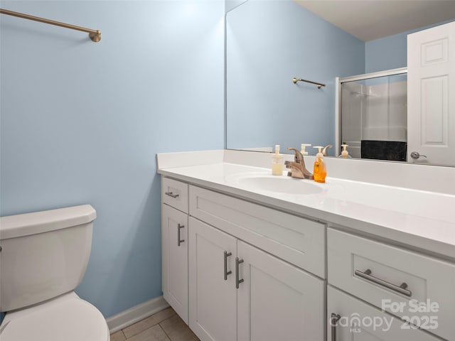 full bath featuring toilet, tile patterned floors, a shower stall, and vanity