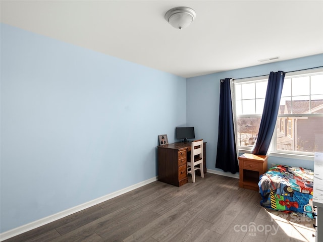 home office featuring baseboards, visible vents, and wood finished floors