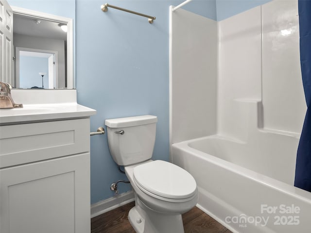 bathroom with  shower combination, vanity, toilet, and wood finished floors