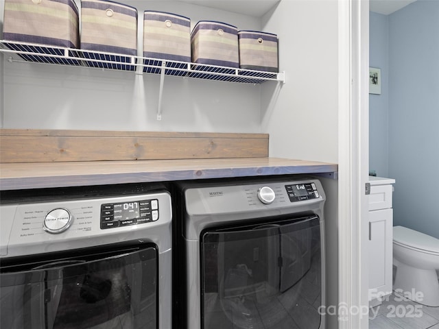 clothes washing area featuring laundry area and washing machine and dryer