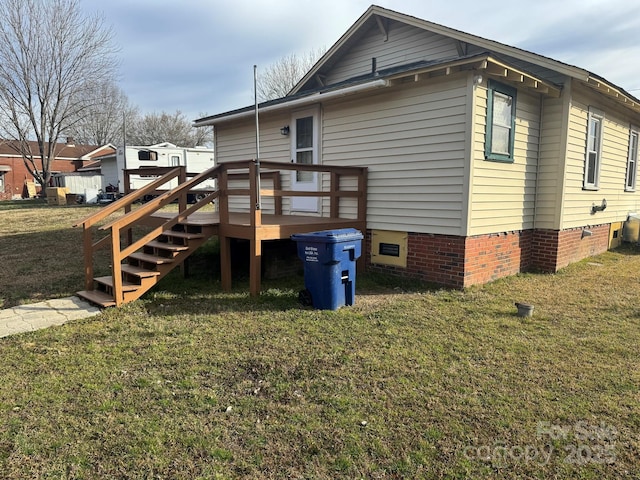 view of home's exterior with crawl space, a yard, and a wooden deck