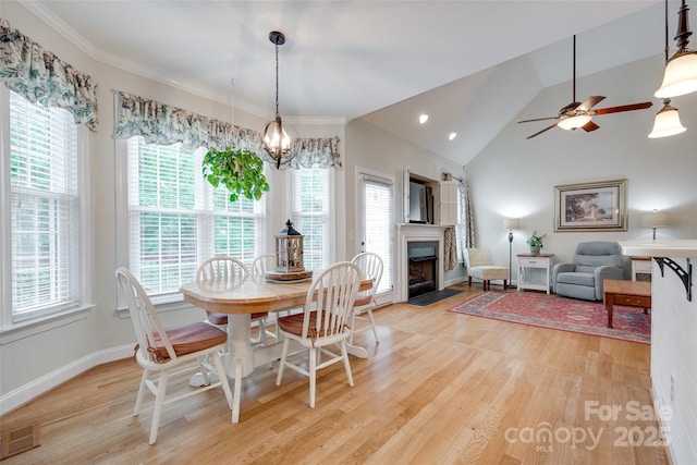2050 Sunswept Ln, York, SC 29745 - dining room with light wood finished floors, a chandelier, a fireplace with flush hearth, vaulted ceiling, and baseboards