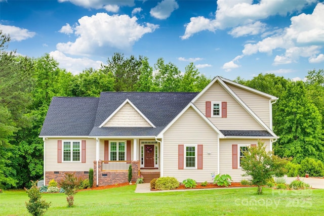 2050 Sunswept Ln, York, SC 29745 - traditional-style home featuring covered porch, a front lawn, roof with shingles, crawl space, and view of wooded area
