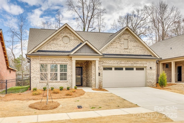 view of front of property featuring a garage, brick siding, fence, concrete driveway, and roof with shingles