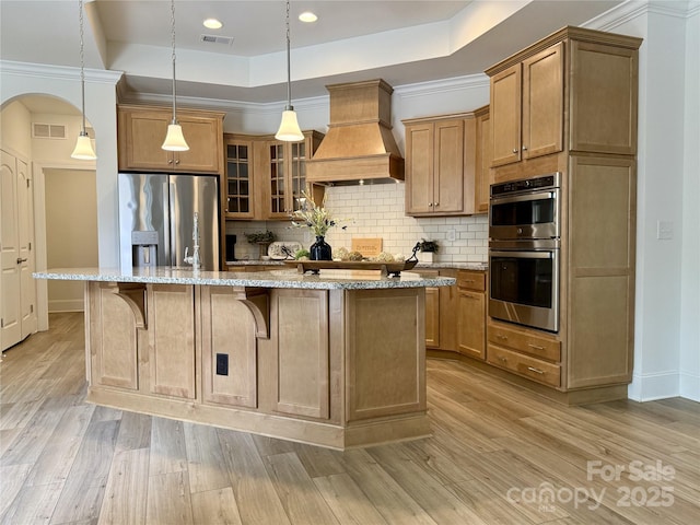 333 Lifestyle Ct, Cramerton, NC 28056 - kitchen featuring premium range hood, appliances with stainless steel finishes, backsplash, light wood finished floors, and recessed lighting