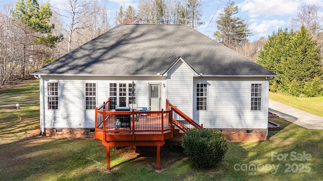 rear view of property featuring crawl space, a yard, roof with shingles, and a deck