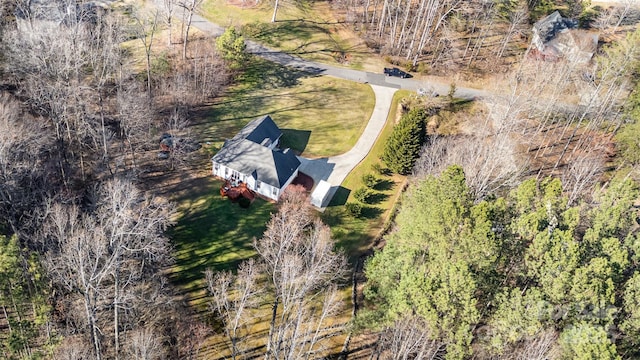 birds eye view of property featuring a view of trees