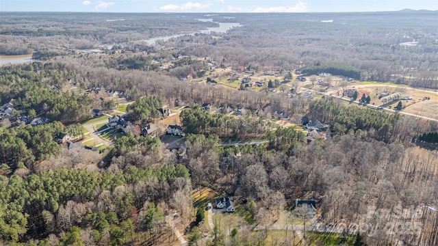 drone / aerial view with a wooded view