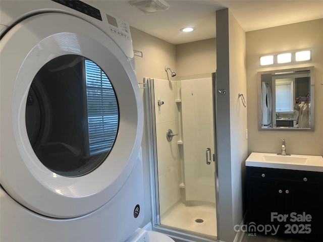 full bath featuring vanity, washer / dryer, visible vents, and a stall shower