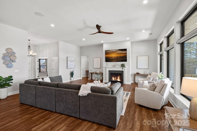 living room with a glass covered fireplace, recessed lighting, and wood finished floors