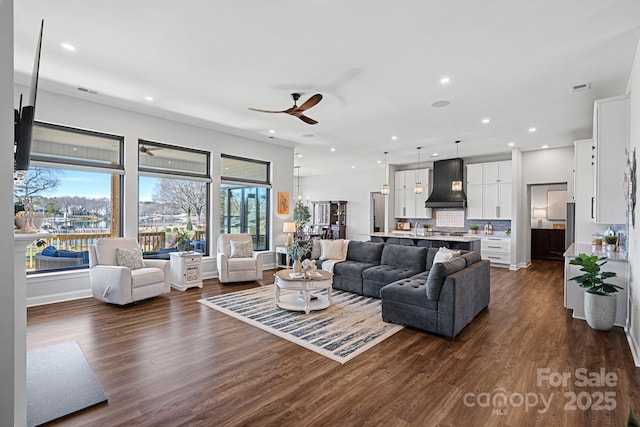 living room with ceiling fan, dark wood-type flooring, visible vents, and recessed lighting