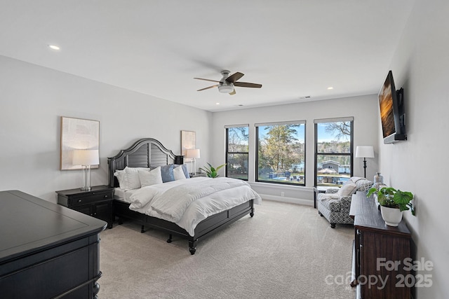 bedroom featuring recessed lighting, light colored carpet, ceiling fan, and baseboards