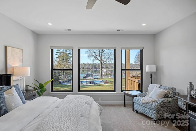 carpeted bedroom featuring multiple windows, visible vents, and recessed lighting