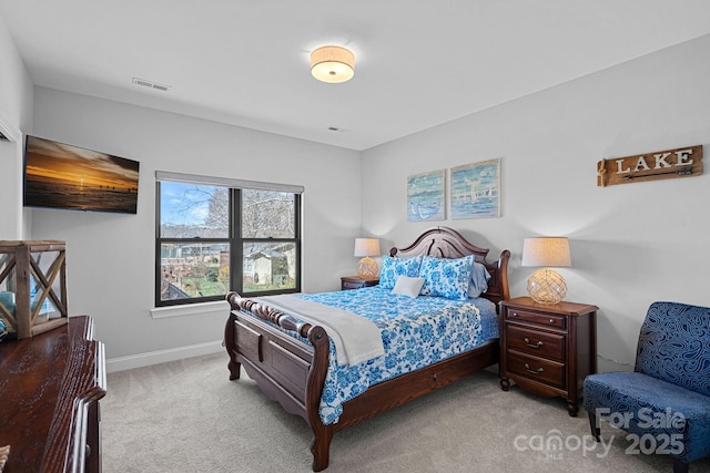 carpeted bedroom featuring baseboards and visible vents