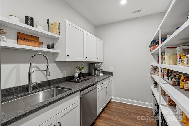 kitchen featuring open shelves, visible vents, stainless steel dishwasher, a sink, and dark stone countertops