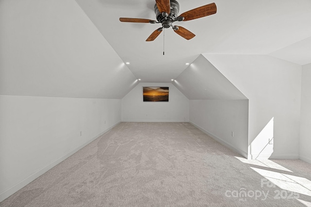 bonus room featuring light colored carpet, vaulted ceiling, baseboards, and ceiling fan