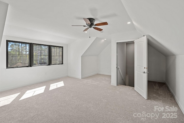 additional living space featuring lofted ceiling, recessed lighting, baseboards, and light colored carpet