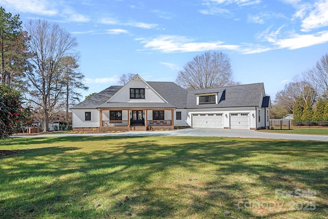 modern farmhouse style home featuring a garage, driveway, and a front lawn