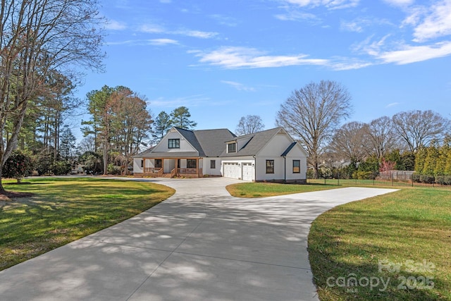 modern farmhouse style home featuring driveway, a front lawn, an attached garage, and fence