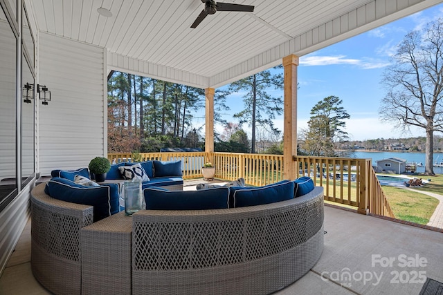 view of patio / terrace featuring outdoor lounge area, a ceiling fan, and a deck with water view